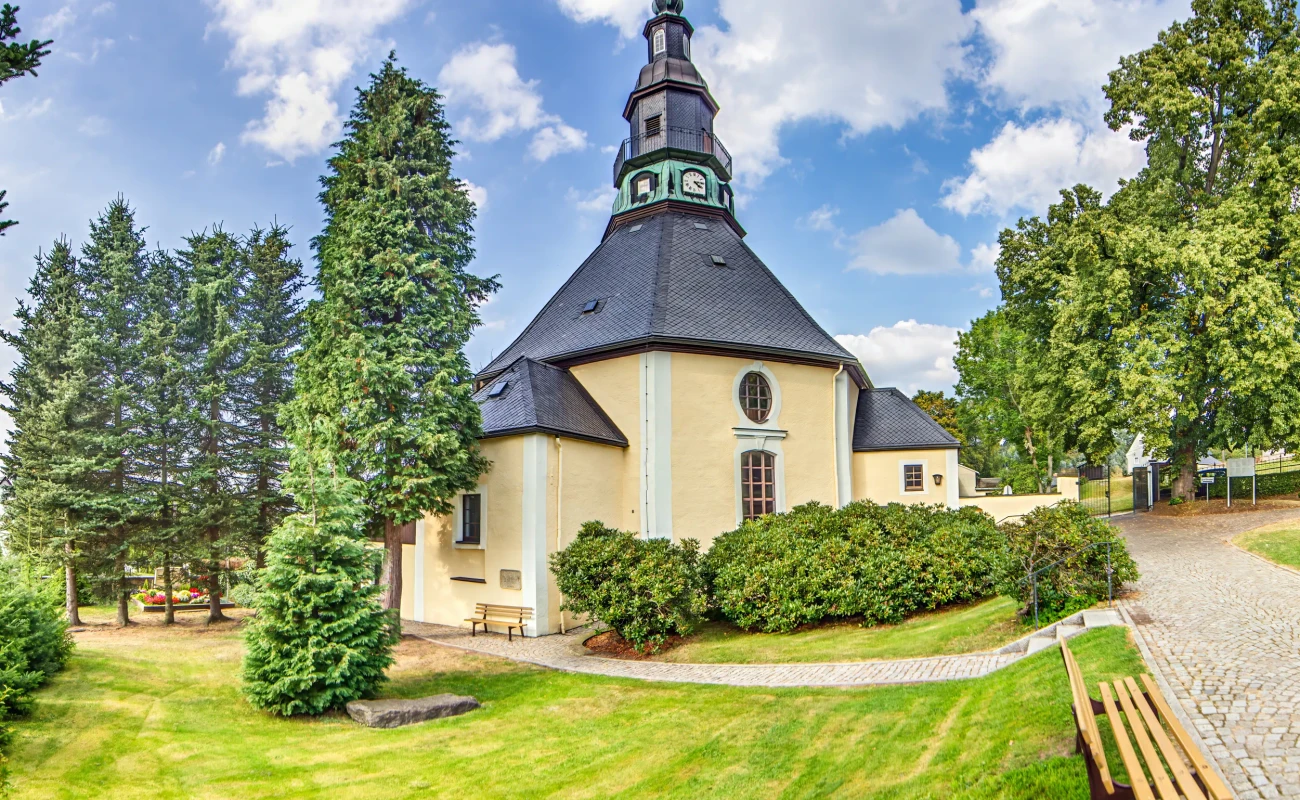 Famous baroque round church in Seiffen Erzgebirge Germany surrounded by trees no people visible