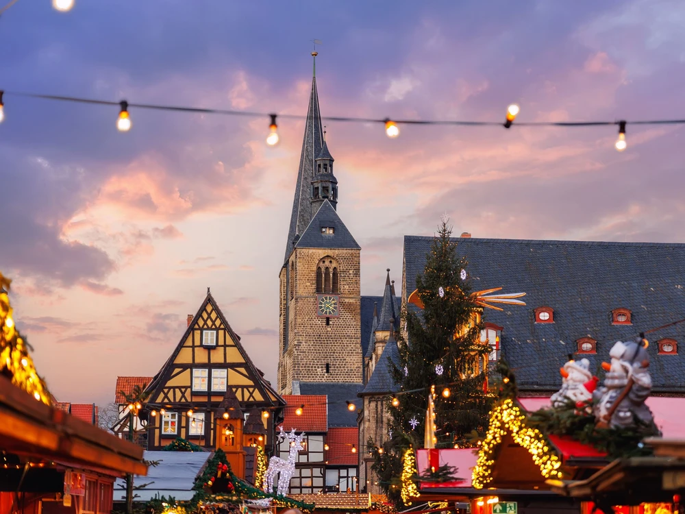 Charming Quedlinburg old traditional German Christmas Market square city center carousel Christmas tree light  decoration. Christmas and new year celebration season. Advent festive New year fair.