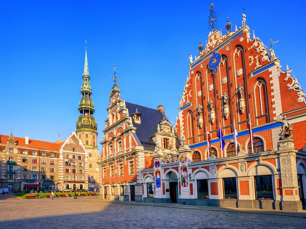 City Hall Square with House of the Blackheads and Saint Peter church in Old Town of Riga in sunset light, Latvia