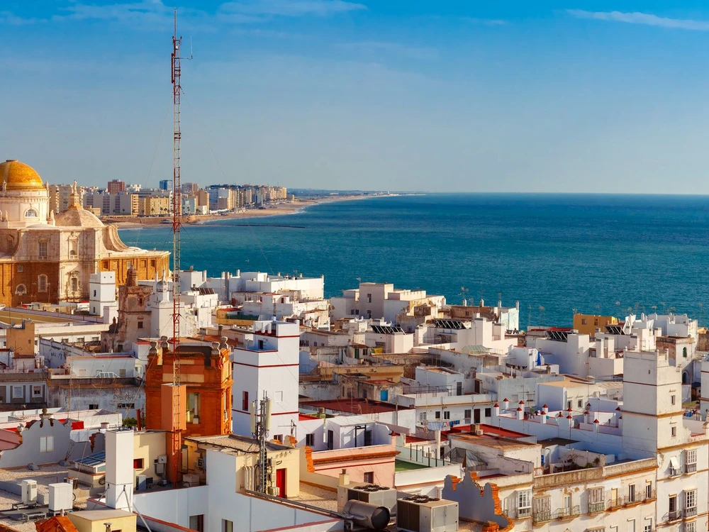 Aerial panoramic view of the old city rooftops and Cathedral de Santa Cruz in the morning from tower Tavira in Cadiz, Andalusia, Spain