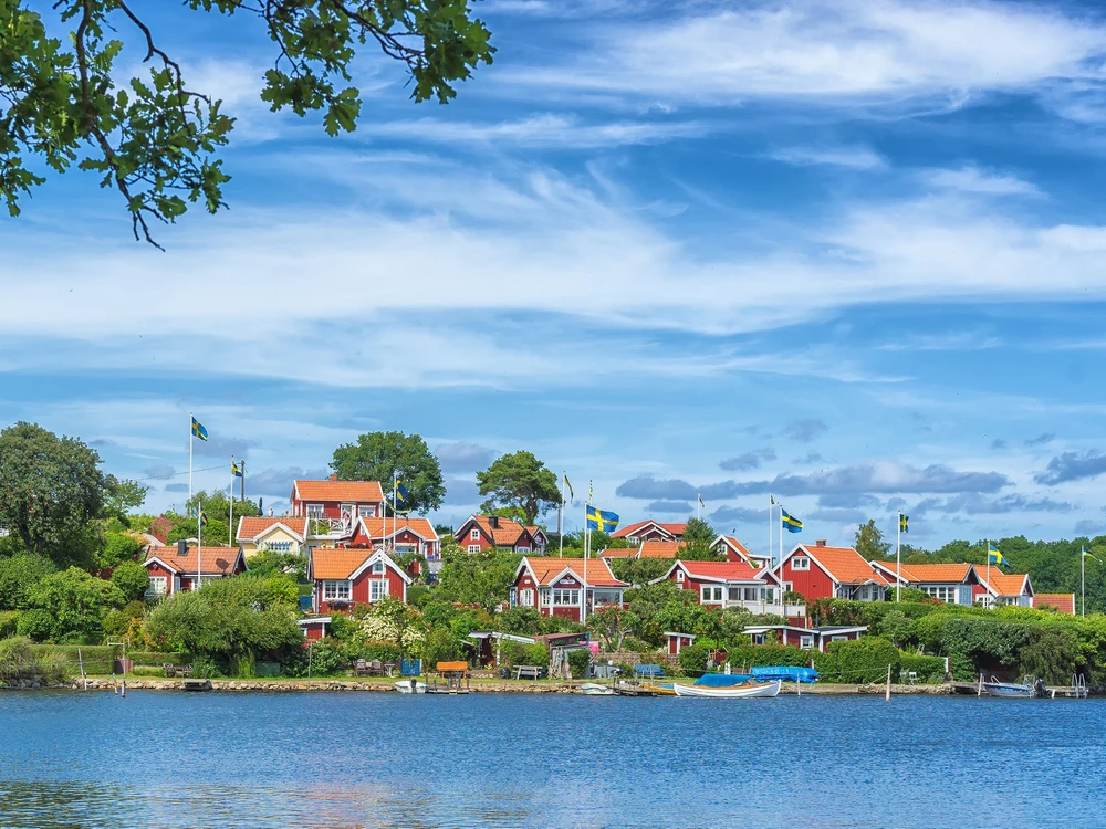 KARLSKRONA, SWEDEN - 2017 July. Typical red Swedish wooden houses with natiaonal flag in the city of Karlskrona.