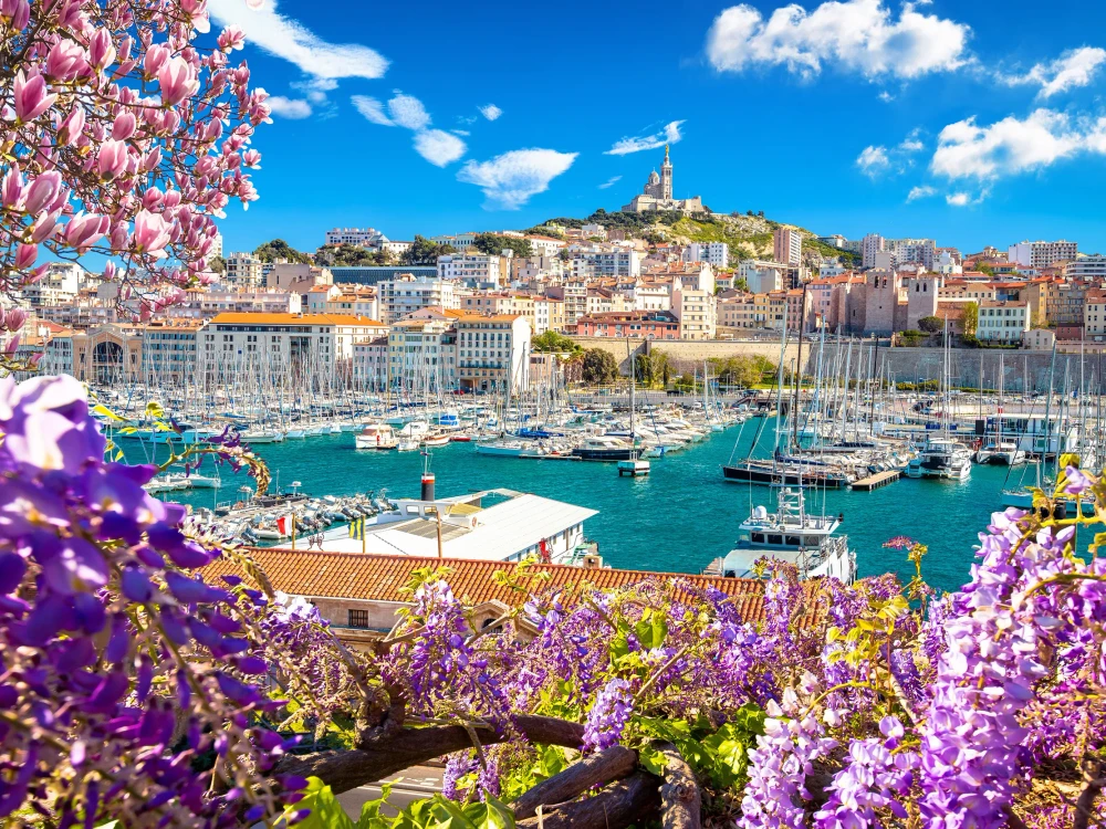 City of Marseille harbor and Notre Dame de la Garde church on the hill flower frame view, southern France