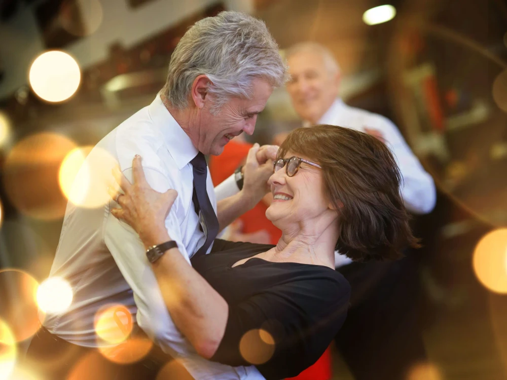 Romantic senior couple dancing together at dance hall