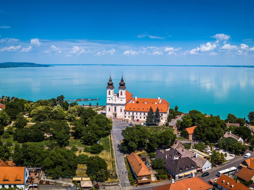 Tihany, Hungary - Aerial panoramic view of the famous Benedictine Monastery of Tihany (Tihany Abbey) with beautiful coloruful Lake Balaton at background