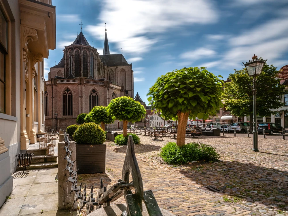 An imposing and impressive Gothic church in the middle of the old city center of a medieval city in the Netherlands.