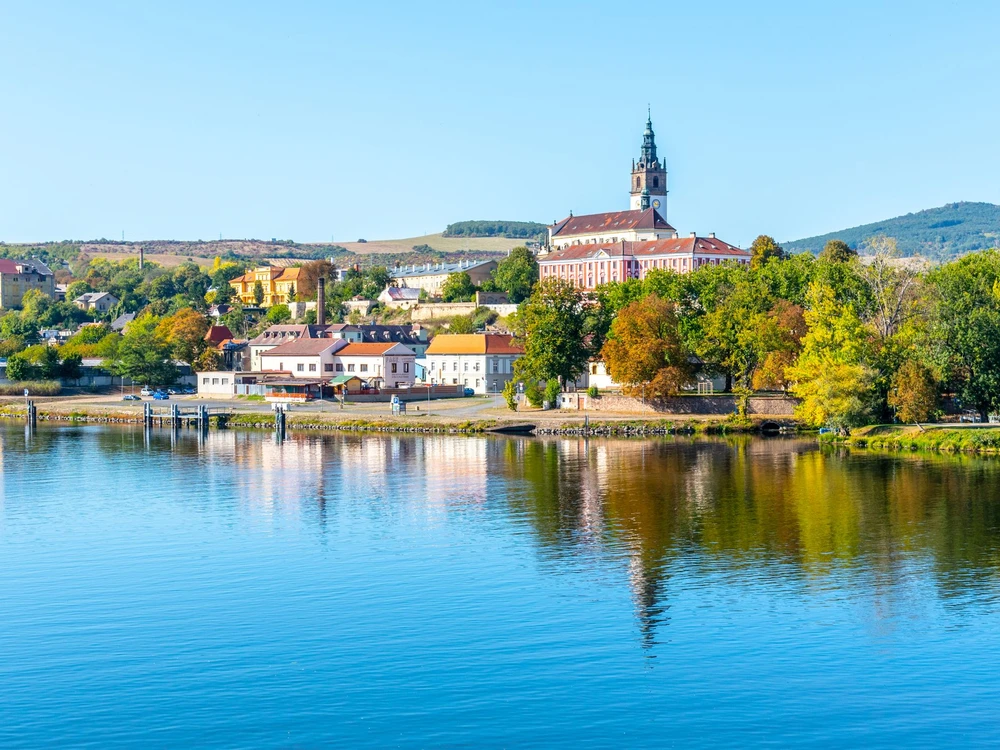 Panoramic cityscape of Litomerice reflected in Labe River, Czech Republic.