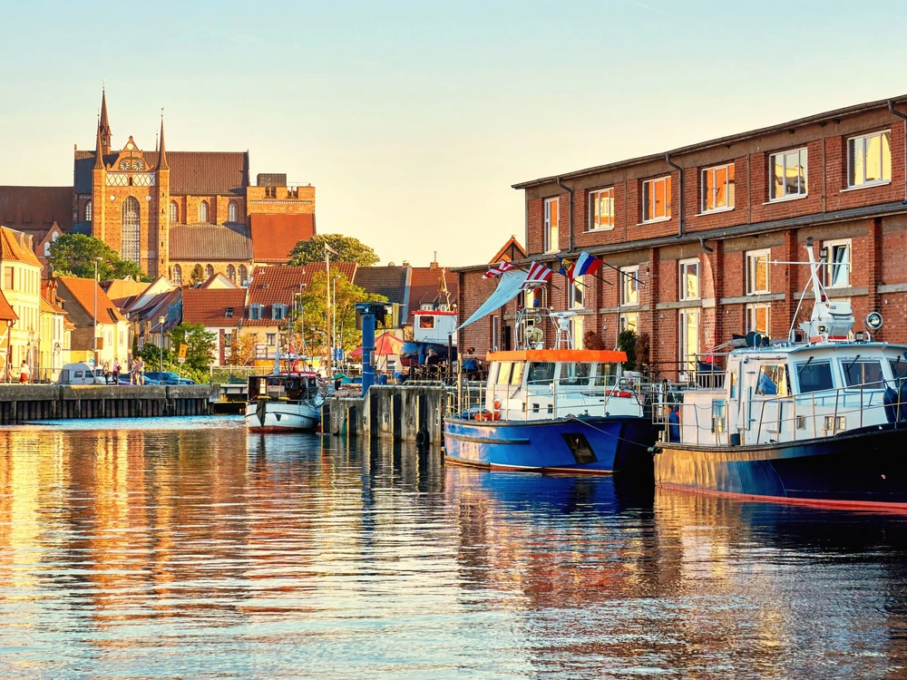 Fishing boats in the harbor of Wismar with a view of the old town. Baltic Sea in Mecklenburg Vorpommern. Germany