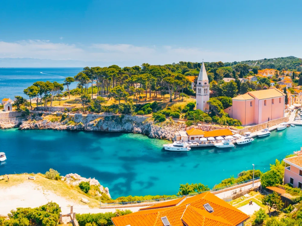 Scenic view of the blue lagoon village Veli Losinj on sunny day. Location place Kvarner Gulf, island Losinj, Croatia, Europe. Drone photography. Summer vacation concept. Discover the beauty of earth.