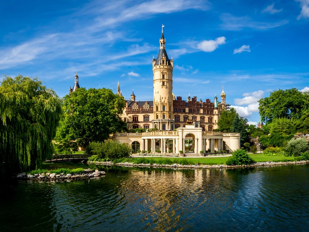 lake view of the popular schwerin castle the seat of the regional government office in mecklenburg western pomerania in front of blue sky with nice cloudscape at daytime on a lovely summer day