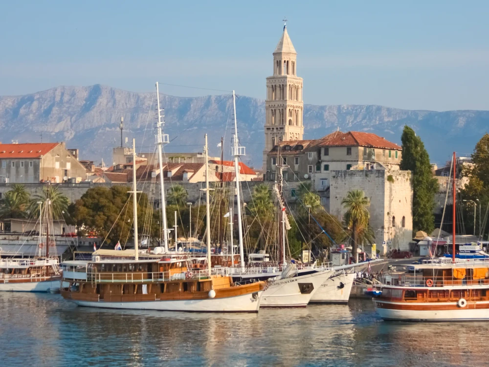 SPLIT - SEPTEMBER 24: Boats in harbour and bell tower on September 24, 2011 in Split, Croatia. The bell tower was originally built in 1100 AD.