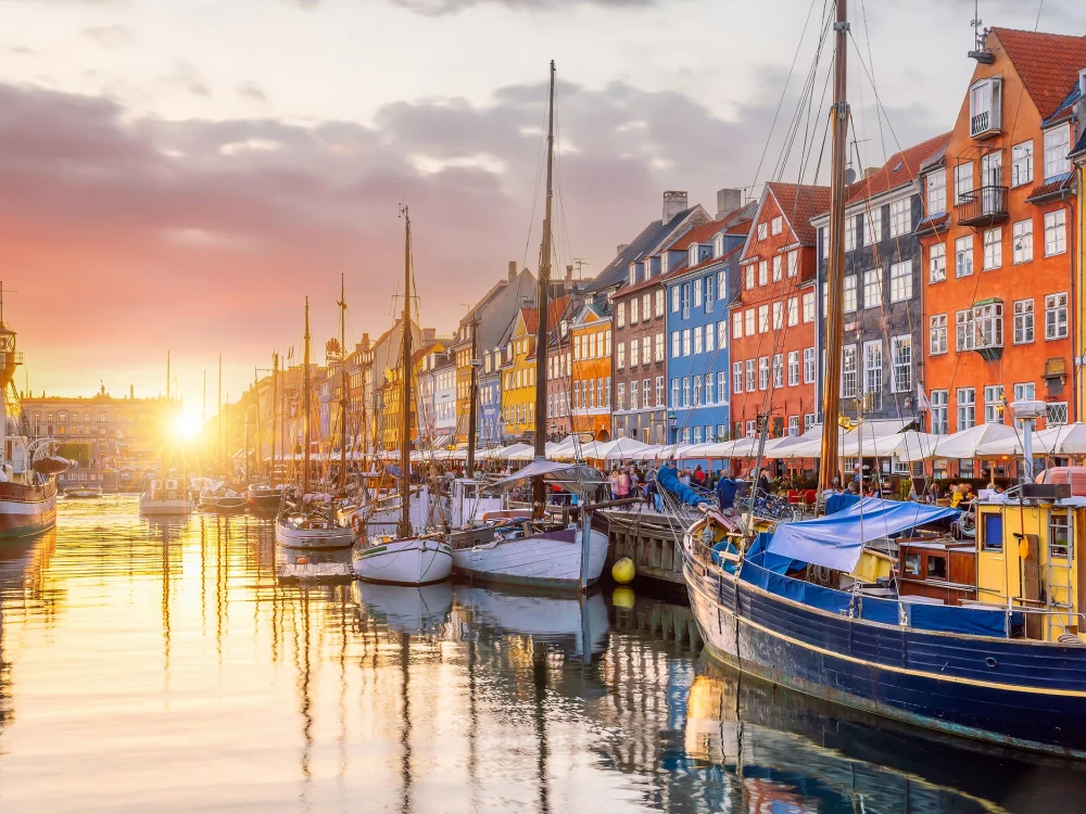 Cityscape of downtown Copenhagen city skyline in Denmark at famous old Nyhavn port at sunset