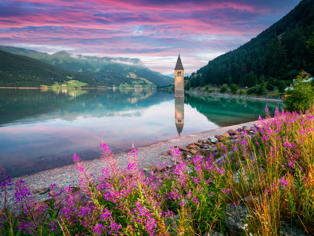 Beautiful view of the lake Resia. Famous tower in the water. Alps, Italy, Europe. Landscape photography
