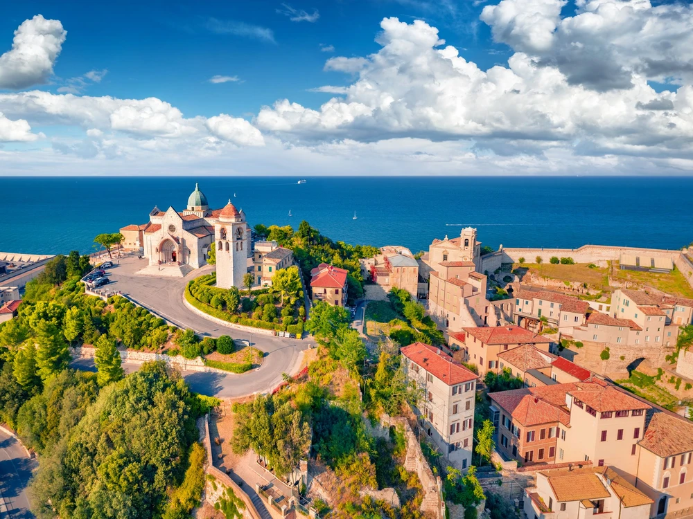 Bright summer view from flying drone of Cattedrale di San Ciriaco church and San Gregorio Illuminatore - Catholic church. Stunning morning cityscape of Ancona town, Italy, Europe.