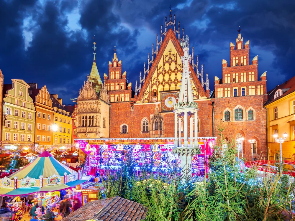 Wroclaw, Poland - December 2019:  Christmas market square. New Year ambiance, illuminated ornamented festive city. Night scene.