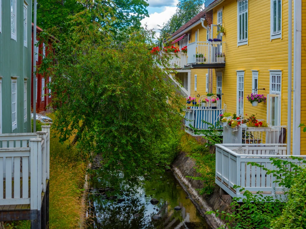 Colorful timber houses alongside a channel in Swedish town Eksjö.
