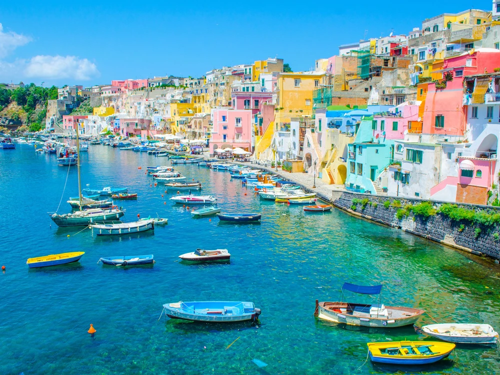 italian island procida is famous for its colorful marina, tiny narrow streets and many beaches which all together attract every year crowds of tourists coming from naples - napoli.