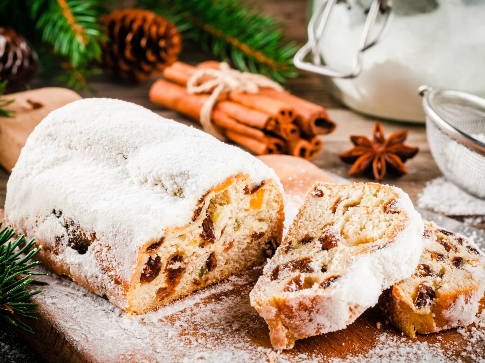 Traditional christmas stollen fruit cake on wooden rustic background