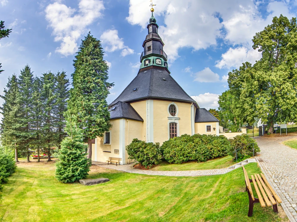 Famous baroque round church in Seiffen Erzgebirge Germany surrounded by trees no people visible