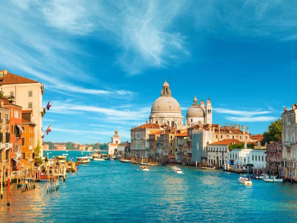 Gorgeous view of the Grand Canal and Basilica Santa Maria della Salute during sunset with interesting clouds, Venice, Italy