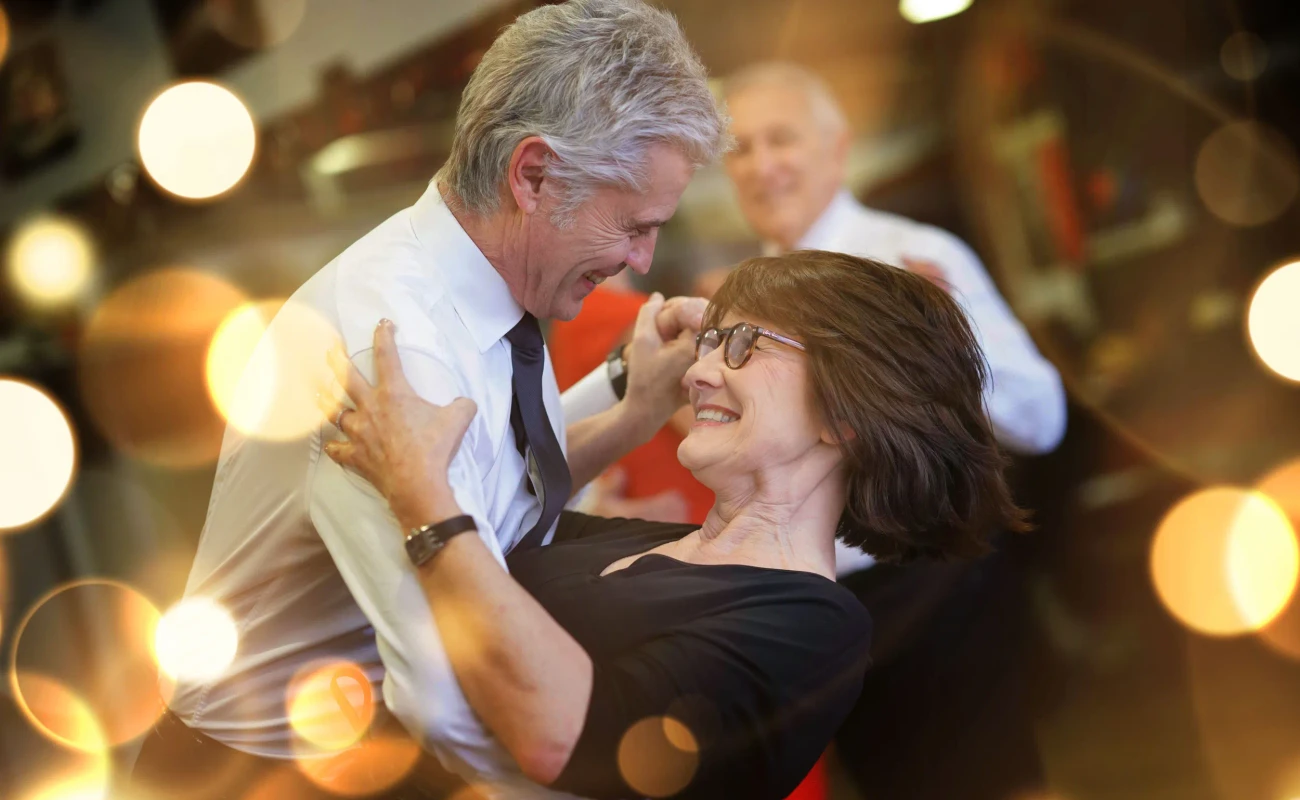 Romantic senior couple dancing together at dance hall