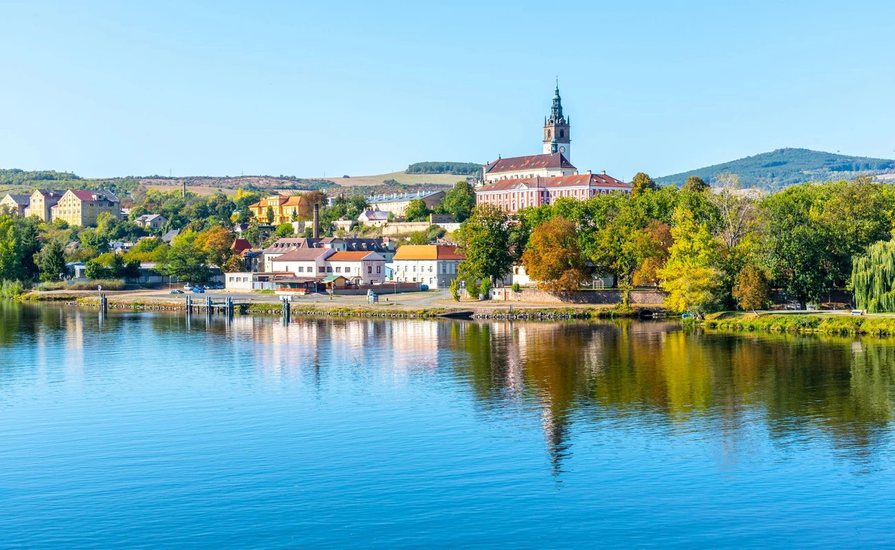 Panoramic cityscape of Litomerice reflected in Labe River, Czech Republic.