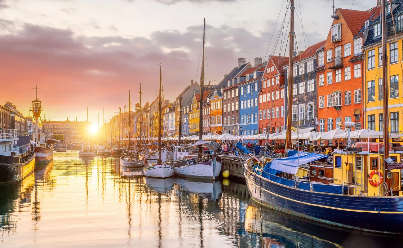 Cityscape of downtown Copenhagen city skyline in Denmark at famous old Nyhavn port at sunset