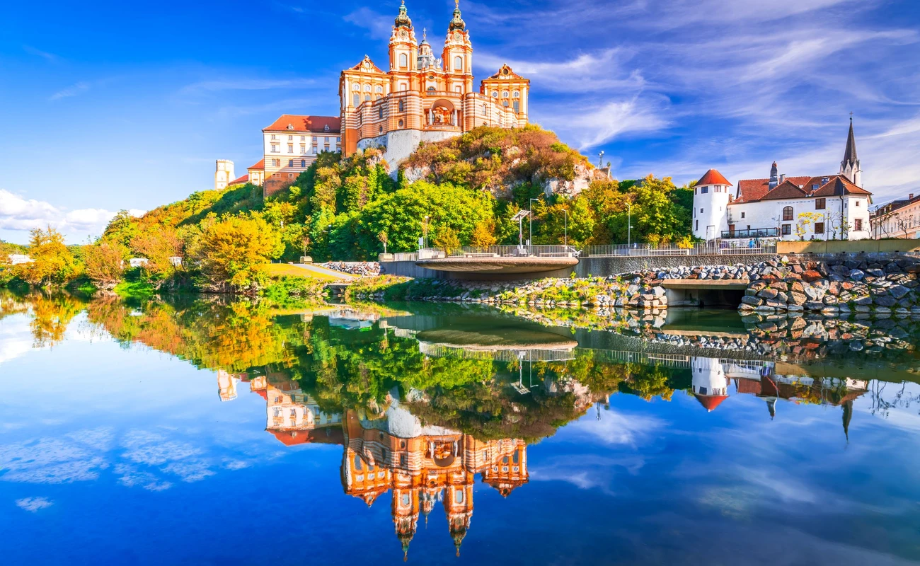 Melk Abbey, Austria. Stift Melk reflected in the water of Danube River, scenic Wachau Valley autumn sunny day.